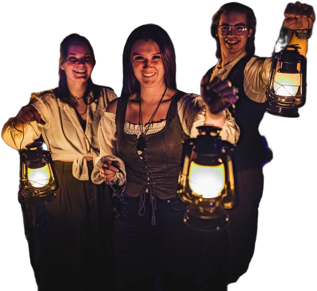 Three players holding glowing lanterns in an escape room at Labyrinth Nampa