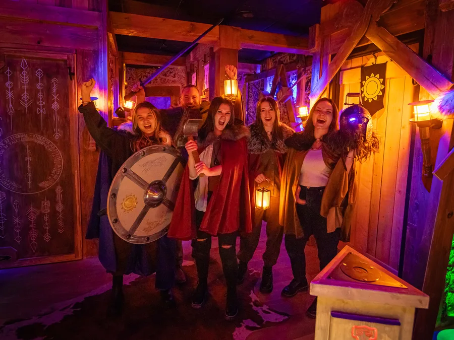 A team in Viking cloaks cheering with a shield and hammer in Ragnarok